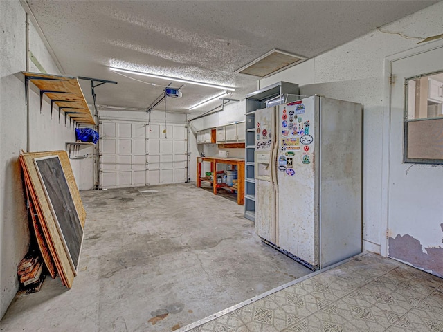 6483 Fabian Rd, North Port, FL 34287 - garage featuring white fridge with ice dispenser and a garage door opener