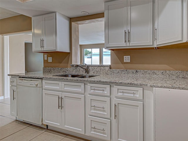 6483 Fabian Rd, North Port, FL 34287 - kitchen with white dishwasher, white cabinetry, light tile patterned floors, and light stone counters