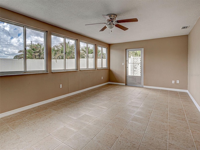 6483 Fabian Rd, North Port, FL 34287 - spare room featuring ceiling fan, light tile patterned floors, and a textured ceiling