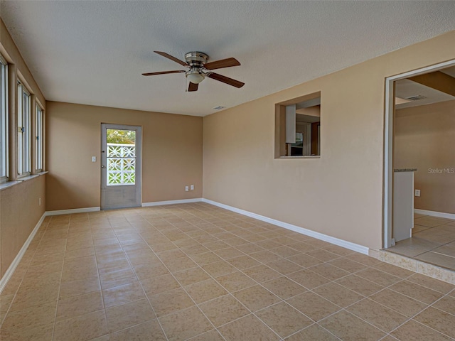 6483 Fabian Rd, North Port, FL 34287 - spare room featuring ceiling fan, light tile patterned floors, and a textured ceiling