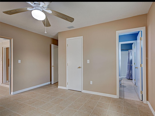 6483 Fabian Rd, North Port, FL 34287 - unfurnished bedroom featuring light tile patterned floors, ensuite bath, and ceiling fan