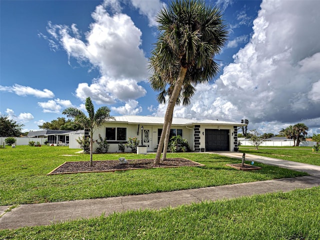 6483 Fabian Rd, North Port, FL 34287 - single story home with a garage, driveway, a front yard, and a metal roof