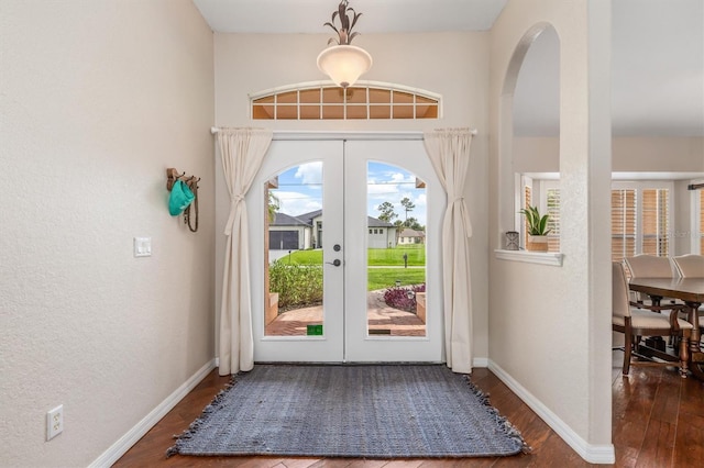 2373 Chartwell Ave, North Port, FL 34288 - foyer with french doors, wood finished floors, arched walkways, and a textured wall