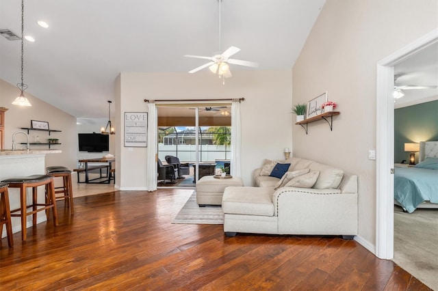2373 Chartwell Ave, North Port, FL 34288 - living room featuring a ceiling fan, vaulted ceiling, and dark wood-style floors