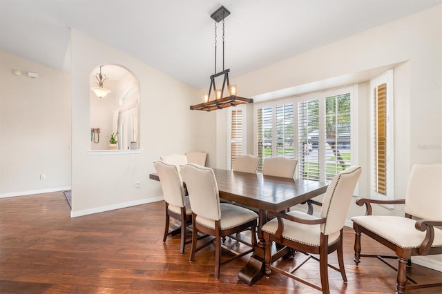 2373 Chartwell Ave, North Port, FL 34288 - dining space with dark wood-style flooring, vaulted ceiling, a chandelier, and arched walkways