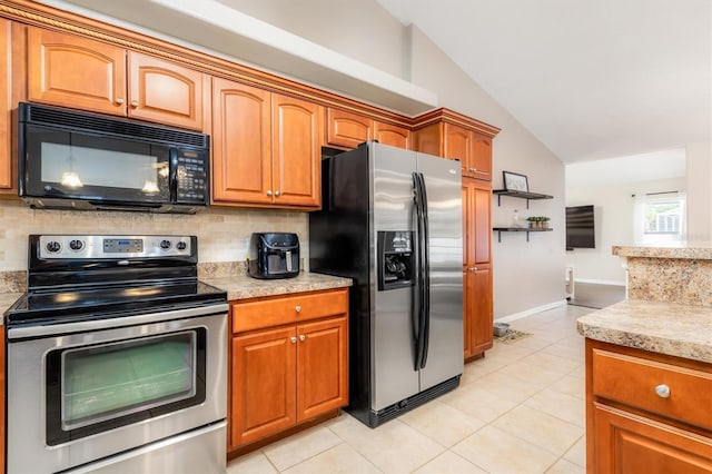 2373 Chartwell Ave, North Port, FL 34288 - kitchen featuring stainless steel appliances, vaulted ceiling, backsplash, light tile patterned flooring, and brown cabinets