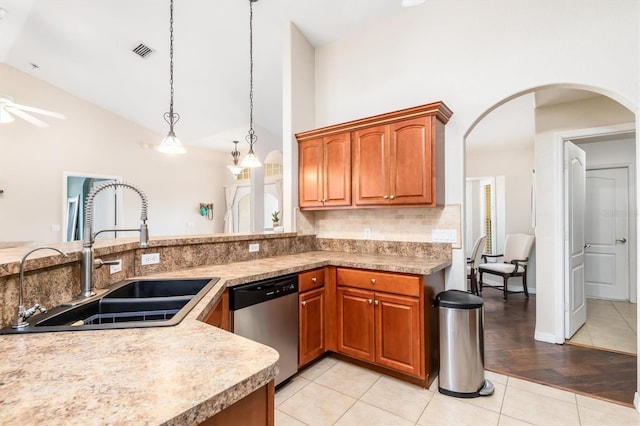 2373 Chartwell Ave, North Port, FL 34288 - kitchen with stainless steel dishwasher, arched walkways, tasteful backsplash, high vaulted ceiling, and brown cabinetry