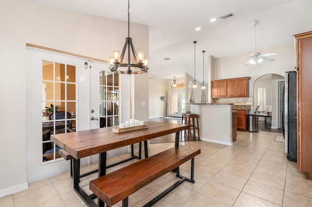 2373 Chartwell Ave, North Port, FL 34288 - dining area with a chandelier, arched walkways, light tile patterned floors, and a ceiling fan