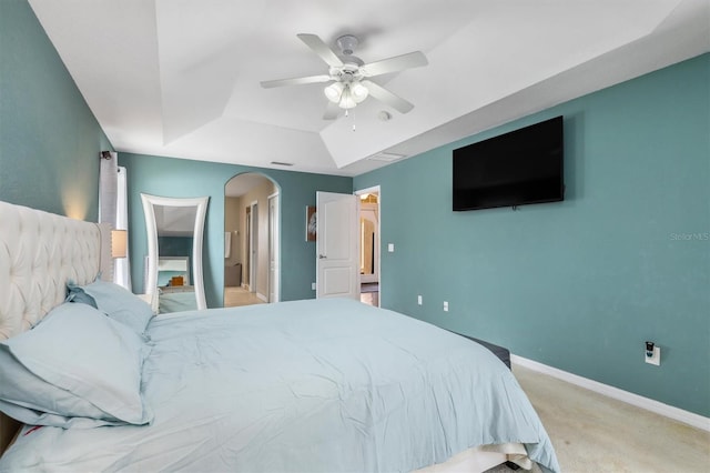 2373 Chartwell Ave, North Port, FL 34288 - carpeted bedroom with a tray ceiling, arched walkways, and a ceiling fan