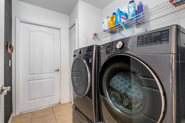 2373 Chartwell Ave, North Port, FL 34288 - laundry area with washing machine and dryer and light tile patterned floors