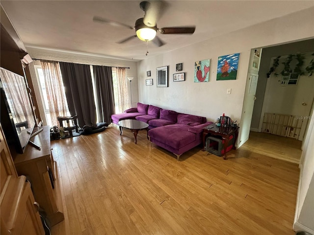 2174 Schwalbe Way, Sarasota, FL 34235 - living room featuring light wood-type flooring, ceiling fan, and healthy amount of natural light