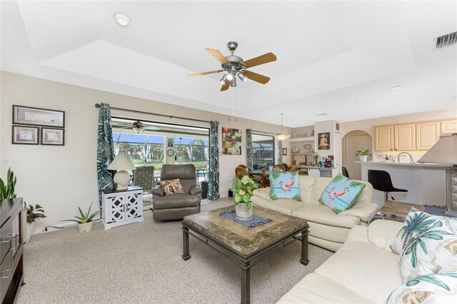 167 Marker Rd, Rotonda West, FL 33947 - carpeted living room with a tray ceiling, ceiling fan, arched walkways, and recessed lighting