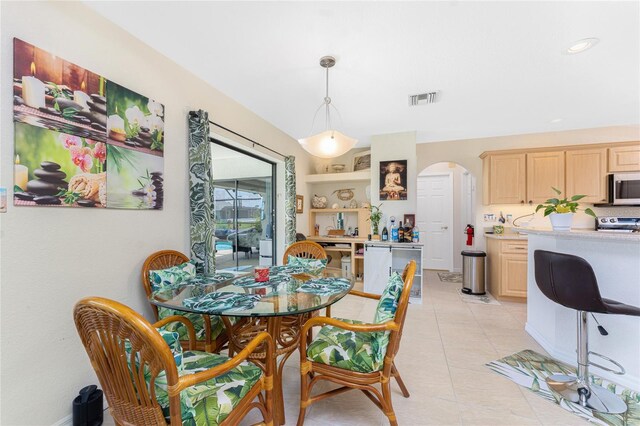 167 Marker Rd, Rotonda West, FL 33947 - dining room featuring arched walkways, light tile patterned floors, and recessed lighting