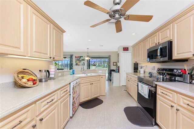 167 Marker Rd, Rotonda West, FL 33947 - kitchen featuring stainless steel appliances, light countertops, light brown cabinets, a peninsula, and ceiling fan
