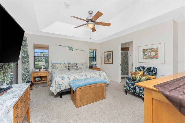 167 Marker Rd, Rotonda West, FL 33947 - bedroom featuring a raised ceiling, light carpet, and ceiling fan