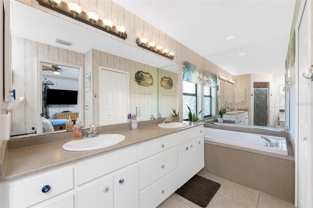 167 Marker Rd, Rotonda West, FL 33947 - ensuite bathroom with double vanity, a bath, tile patterned flooring, and ceiling fan