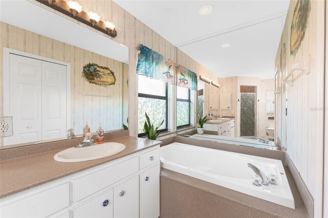 167 Marker Rd, Rotonda West, FL 33947 - full bathroom featuring vanity, a bath, and wooden walls