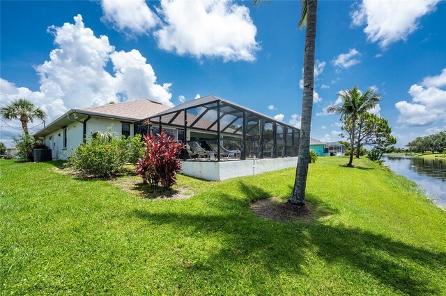 167 Marker Rd, Rotonda West, FL 33947 - view of grassy yard featuring a lanai and a water view