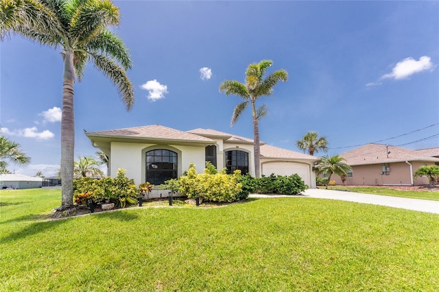 167 Marker Rd, Rotonda West, FL 33947 - mediterranean / spanish home featuring concrete driveway, an attached garage, a front yard, and stucco siding