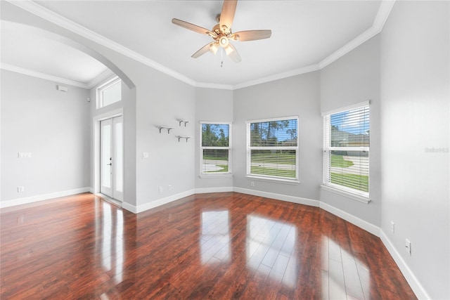 1523 Napoleon Rd, North Port, FL 34288 - unfurnished room featuring healthy amount of natural light, arched walkways, wood finished floors, and crown molding