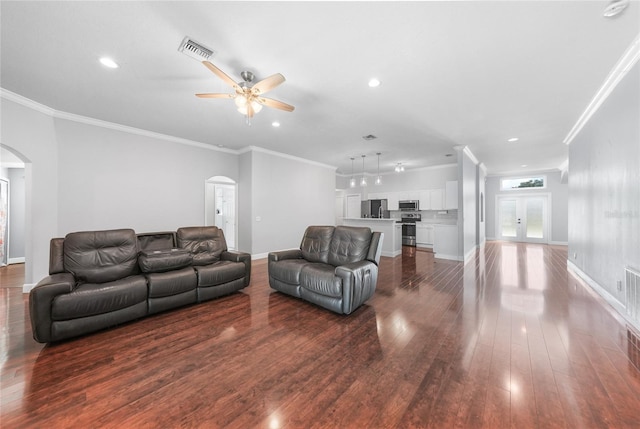 1523 Napoleon Rd, North Port, FL 34288 - living area with arched walkways, dark wood finished floors, ornamental molding, ceiling fan, and recessed lighting