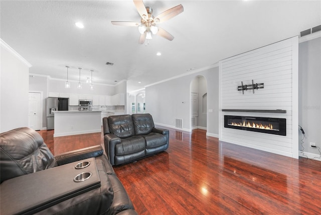 1523 Napoleon Rd, North Port, FL 34288 - living area featuring ornamental molding, ceiling fan, dark wood-style flooring, arched walkways, and recessed lighting
