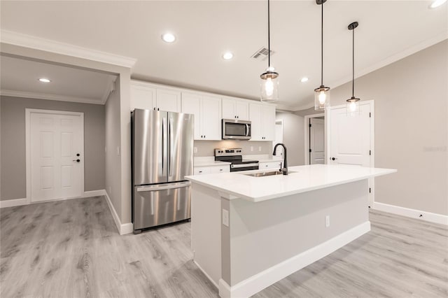 16403 Perdida Ct, Punta Gorda, FL 33955 - kitchen with appliances with stainless steel finishes, crown molding, an island with sink, recessed lighting, and white cabinetry