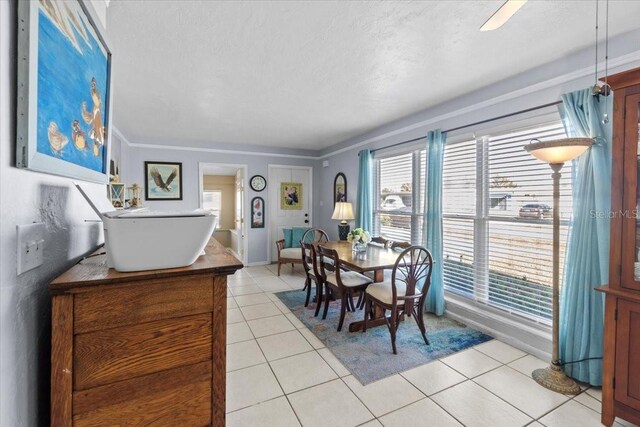 3197 Normandy Dr, Port Charlotte, FL 33952 - dining space with light tile patterned floors, healthy amount of natural light, and ornamental molding