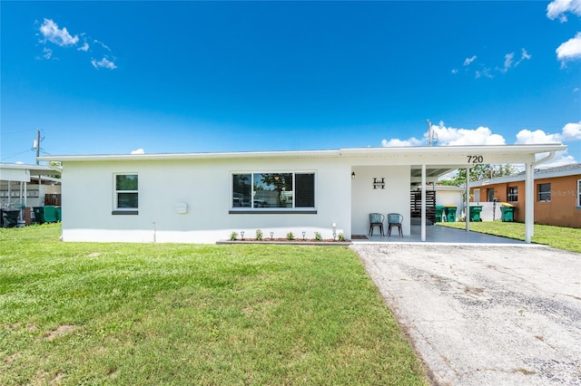 720 Dalton Blvd, Port Charlotte, FL 33952 - view of front of property featuring stucco siding, driveway, a carport, and a front lawn