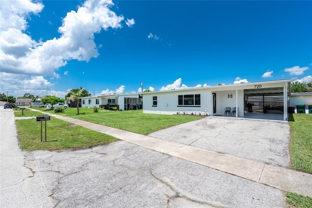 720 Dalton Blvd, Port Charlotte, FL 33952 - single story home with driveway, a front yard, stucco siding, and an attached carport