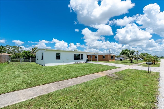 720 Dalton Blvd, Port Charlotte, FL 33952 - view of front facade with concrete driveway, stucco siding, and a carport