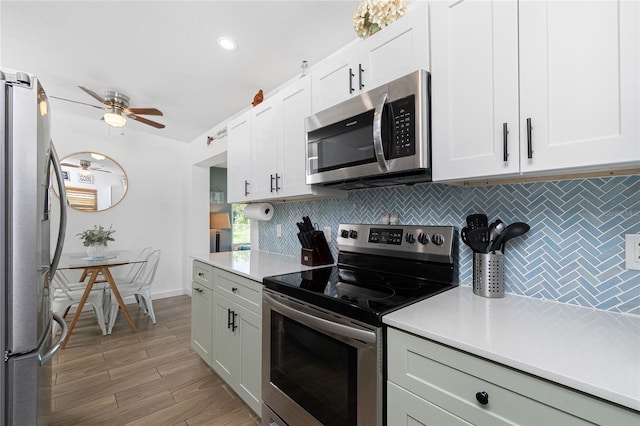 720 Dalton Blvd, Port Charlotte, FL 33952 - kitchen with stainless steel appliances, backsplash, light countertops, ceiling fan, and white cabinets