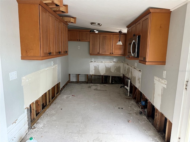 420 W Olympia Ave, Punta Gorda, FL 33950 - kitchen featuring stainless steel microwave, brown cabinets, and decorative light fixtures