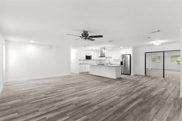 4996 49th St, Vero Beach, FL 32967 - unfurnished living room with light wood-style floors, ceiling fan, and recessed lighting