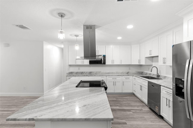 4996 49th St, Vero Beach, FL 32967 - kitchen featuring appliances with stainless steel finishes, island exhaust hood, a kitchen island, light wood finished floors, and white cabinetry