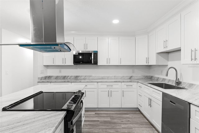 4996 49th St, Vero Beach, FL 32967 - kitchen with stainless steel appliances, island range hood, white cabinetry, and recessed lighting