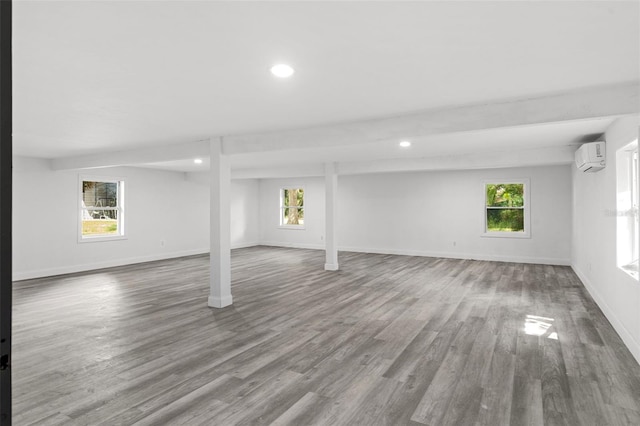 4996 49th St, Vero Beach, FL 32967 - below grade area featuring wood finished floors, healthy amount of natural light, a wall mounted AC, and recessed lighting