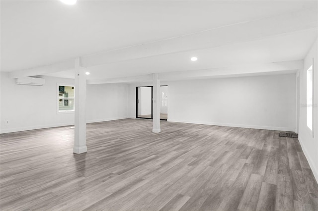 4996 49th St, Vero Beach, FL 32967 - basement featuring an AC wall unit, wood finished floors, and recessed lighting
