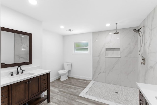 4996 49th St, Vero Beach, FL 32967 - bathroom featuring vanity, a marble finish shower, recessed lighting, and wood finished floors