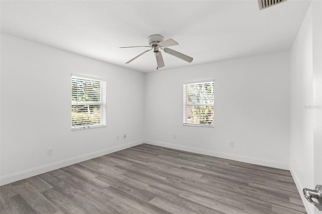 4996 49th St, Vero Beach, FL 32967 - spare room featuring healthy amount of natural light, ceiling fan, and wood finished floors