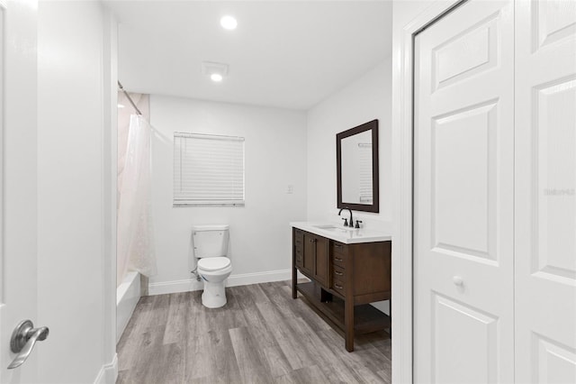 4996 49th St, Vero Beach, FL 32967 - bathroom featuring vanity, wood finished floors, shower / bath combination with curtain, and recessed lighting