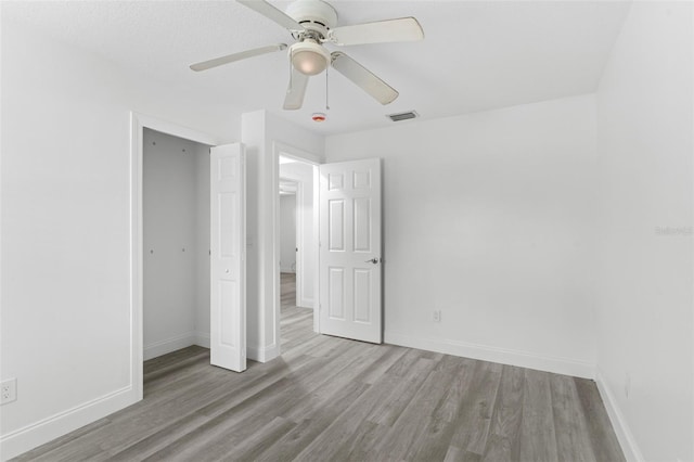 4996 49th St, Vero Beach, FL 32967 - unfurnished bedroom with wood finished floors, a closet, and a ceiling fan