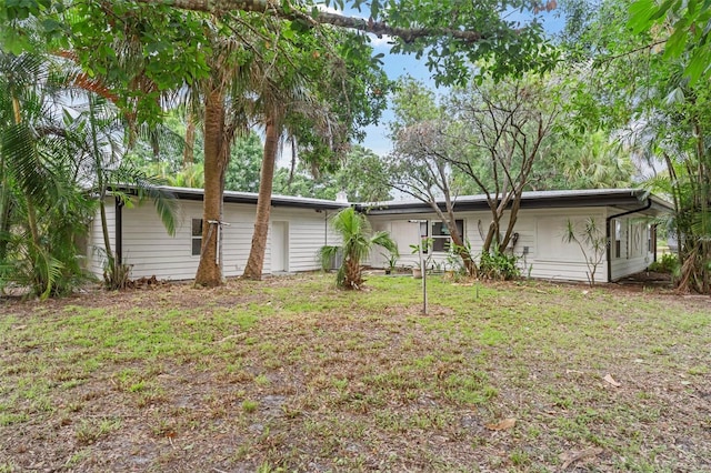 4996 49th St, Vero Beach, FL 32967 - rear view of property featuring a yard
