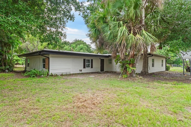 4996 49th St, Vero Beach, FL 32967 - back of house with a lawn
