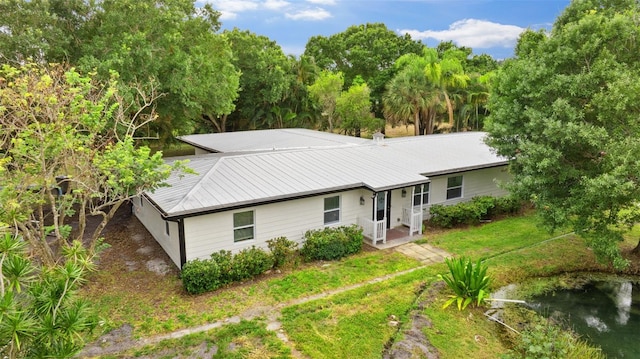 4996 49th St, Vero Beach, FL 32967 - back of house featuring a metal roof