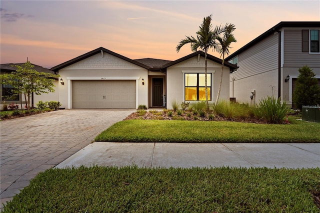 2477 Gabel Oak Dr, North Port, FL 34289 - ranch-style house featuring a garage, decorative driveway, a yard, and stucco siding