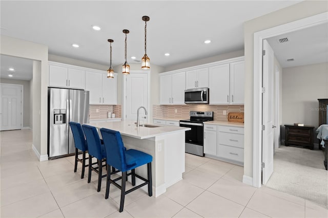 2477 Gabel Oak Dr, North Port, FL 34289 - kitchen with stainless steel appliances, white cabinetry, backsplash, and recessed lighting