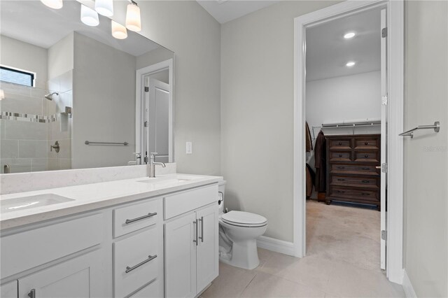 2477 Gabel Oak Dr, North Port, FL 34289 - full bath with double vanity, tiled shower, a spacious closet, and tile patterned floors