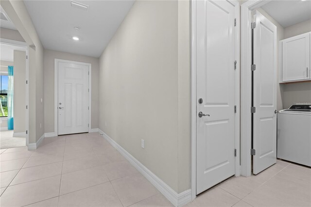 2477 Gabel Oak Dr, North Port, FL 34289 - corridor with washer / clothes dryer, light tile patterned floors, and recessed lighting