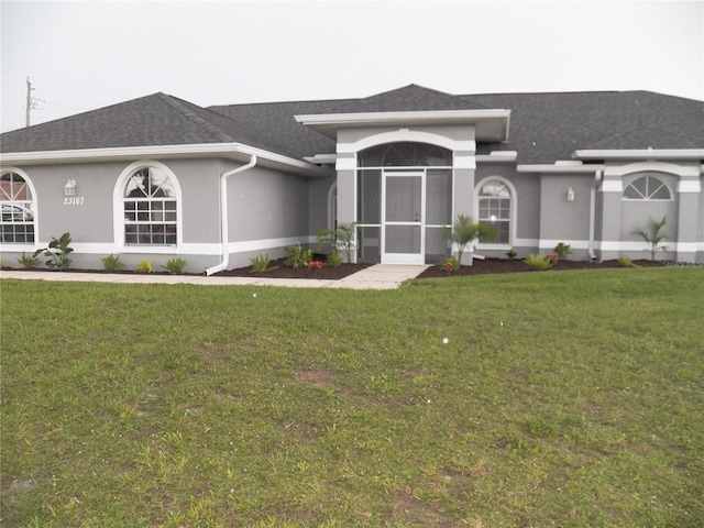 23167 Turnbull Ave, Port Charlotte, FL 33954 - single story home featuring stucco siding, a front lawn, and roof with shingles